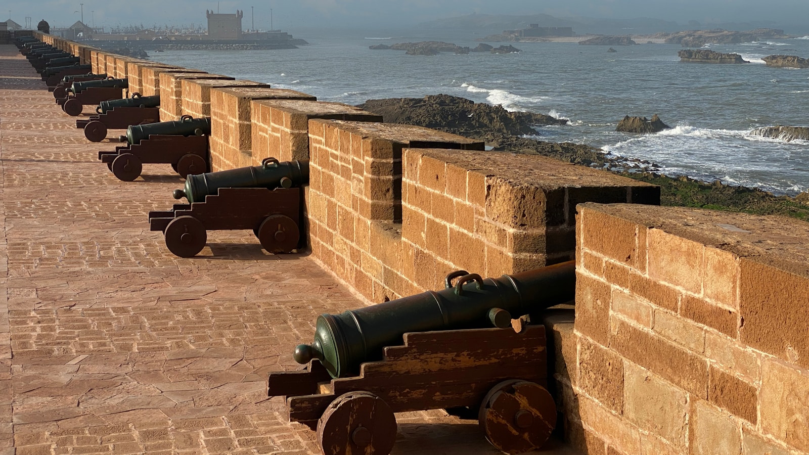 a brick wall with cannons on it